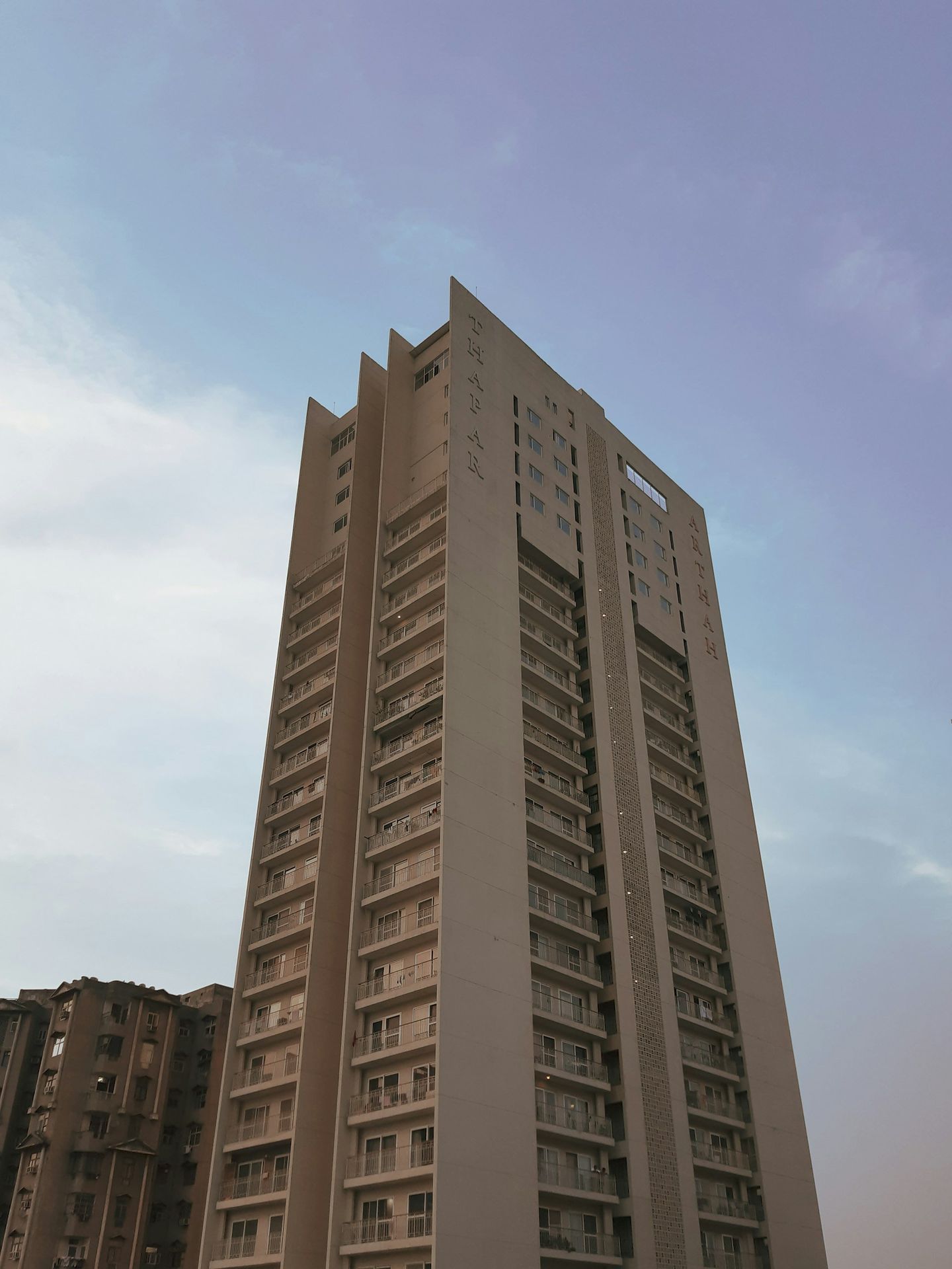 a tall building sitting next to a parking lot